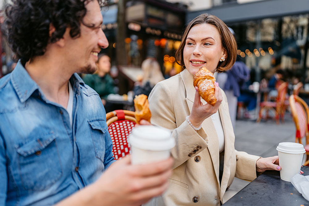 Young Couple Enjoying a Coffee and Croissant Breakfast