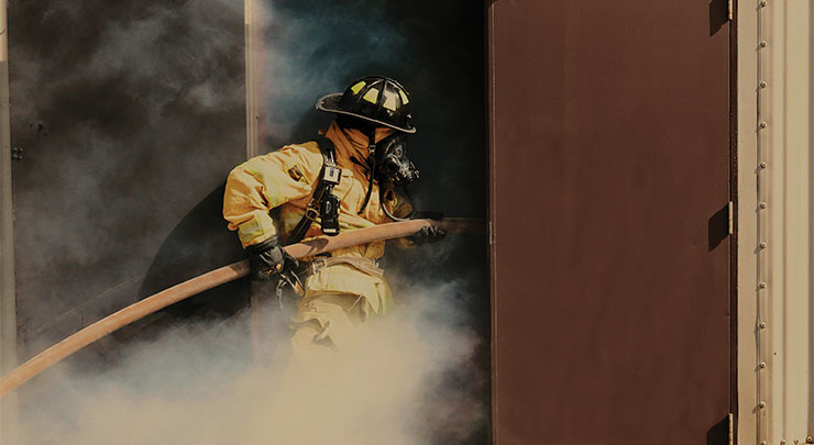 Firefighter with a fire hose