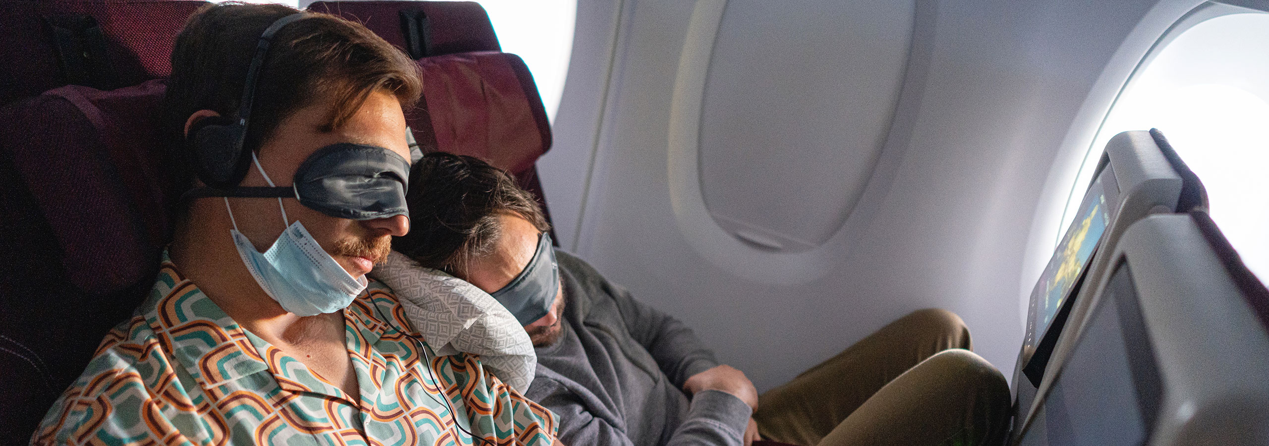 male friends sleeping in the flight