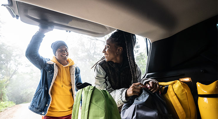 Couple sharing smiles as they are ready for fun fall road trip