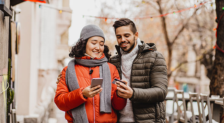 Happy couple shopping online with credit card