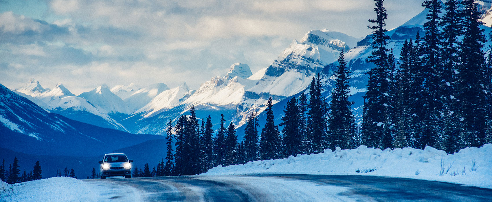 car on a snowing scenic mountain road