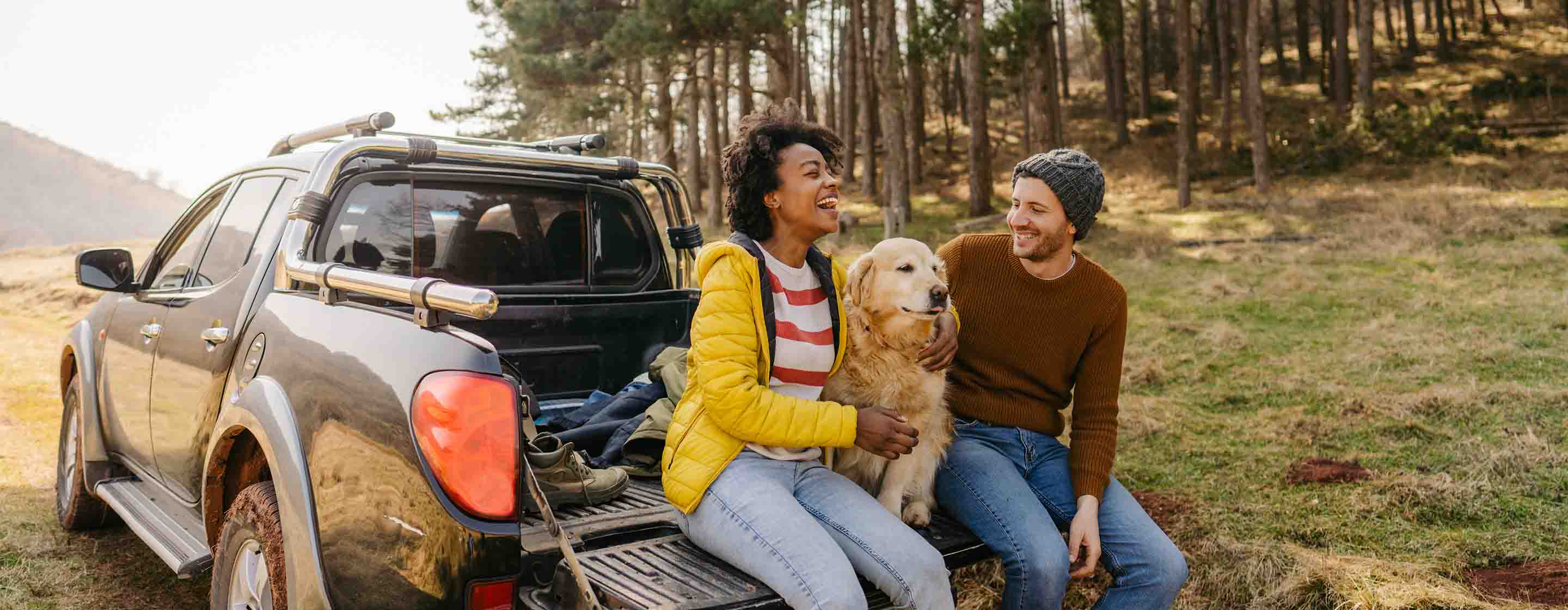 two people on a road trip with dog