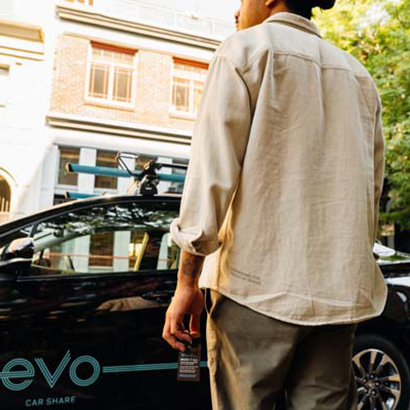 Man holding key fob walking toward Evo